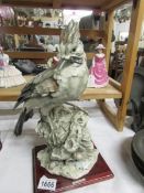 A large ceramic bird figure,