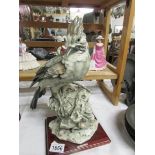 A large ceramic bird figure,