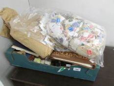 A large box of stamp related ephemera including 2 bags of stamps on paper.