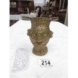 A 19th century Indian cast bronze head of the God Shiva with foliate and scroll decoration,