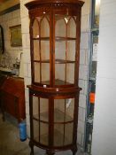 A mahogany astragal glazed corner cabinet.