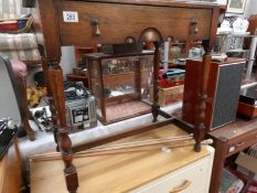 An oak side table with drawer.