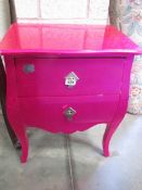 A shocking pink 2 drawer chest.