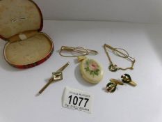 An unusual hand painted locket, a jockey tie clip and a Scottish tie clip with matching earrings.