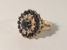An oval diamond and sapphire cluster ring in 9ct gold, size L.