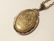 A locket and chain (tests as 9ct gold) approximate total weight 26 grams.