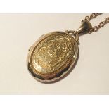 A locket and chain (tests as 9ct gold) approximate total weight 26 grams.