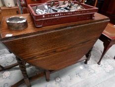 An oak barley twist gate leg table,.