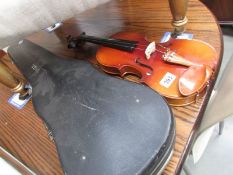 A cased violin with bow