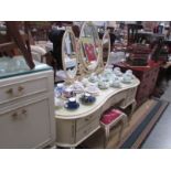 A cream dressing table and stool.