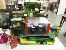 9 boxed John Deere tractors and a Massey Ferguson tractor.