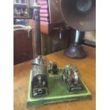 A German tin plate toy steam plant with boiler, chimney and generator driving a light plant.