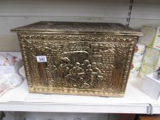 A polished brass log box.