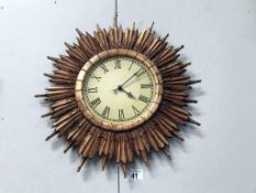 An art deco style sunburst wall clock.