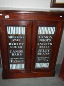 A confectionery cabinet with sign written doors.