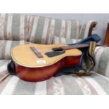 An acoustic guitar with soft case.