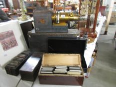 An old brass magic lantern projector in wooden box/stand and four boxes containing approximately