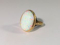 A 9ct yellow gold ring set large opal, size M.