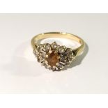 An 18ct gold ring set with diamonds and smoky quartz, size N.