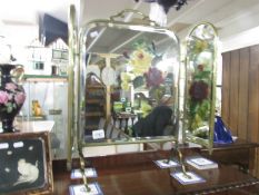 A triple brass fire screen with hand painted mirror panels.