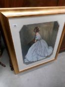 A gilt framed and glazed print of a lady in ball gown.