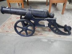 A cast iron model of a circa 18/19th century cannon on carriage, approximate length 35", height 14",