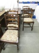 An oak gateleg table and 4 chairs,.