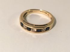 A diamond and sapphire 7 stone ring in 9ct gold,