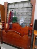 A Victorian mahogany bed frame with metal base.