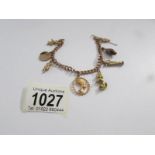 A 9ct gold charm bracelet with gold and yellow metal charms, total weight 19 grams.