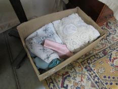 A box of lace and linen fabrics.