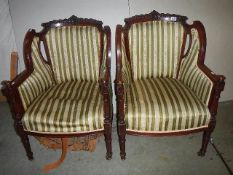 A pair of mahogany framed chairs with Regency stripe upholstery.