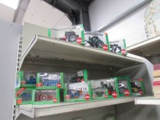 A quantity of boxed Siku farm tractors and implements.
