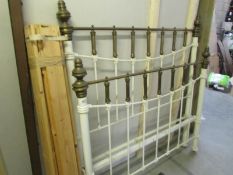 A Victorian brass and iron bedstead with slats.