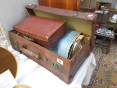 A vintage suitcase, a smaller vintage suitcase, sheet music etc.