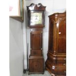 A long case inlaid clock with brass dial.