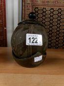 A coconut lidded cup on stand.