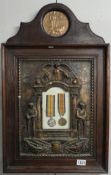 A WW1 memorial plaque for Edwin James Rusher together with 2 medals in a military style memorial