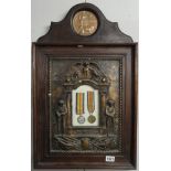 A WW1 memorial plaque for Edwin James Rusher together with 2 medals in a military style memorial