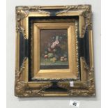 A gilt framed floral picture.