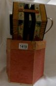 A boxed concertina marked Scholer, in excellent condition.