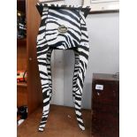 A Zebra patterned single drawer side table.