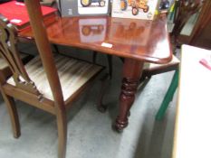 A mahogany extending dining table with 3 leaves.
