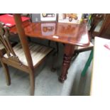 A mahogany extending dining table with 3 leaves.