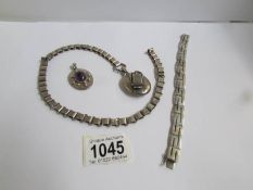 An unmarked white metal locket on heavy metal chain (possibly Scandinavian),