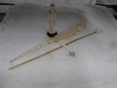 A bone crocodile, back scratcher and figure.