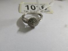 A 9ct white gold ring set small diamonds, size M.