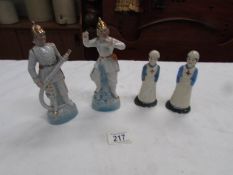 A pair of nurse figures and a pair of fireman figures.