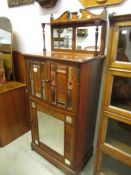 A Victorian mahogany music cabinet with mirrored doors (missing 1 caster).