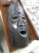 A large carved tribal mask,.